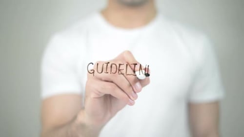 Man Writing Guidelines with Black Marker