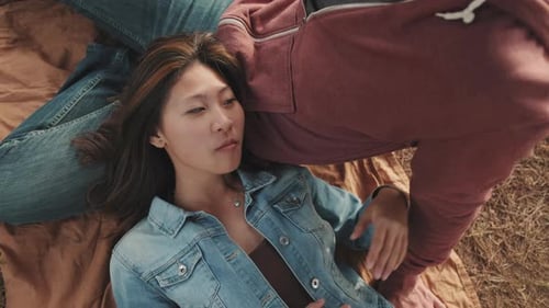 Woman Resting on Man's Lap Outdoors