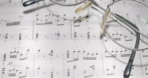 View over musical notes and glasses