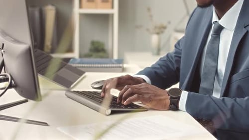 Man Typing on Keyboard in Corporate Office