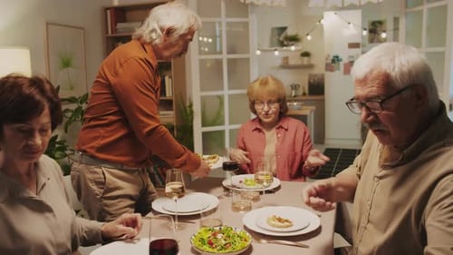 Adults Sharing Dinner at a Cozy Home Gathering