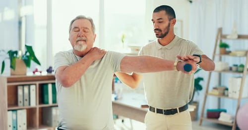Senior Man Doing Physical Therapy With Dumbbell