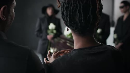 Mourning Woman Comforted at Funeral