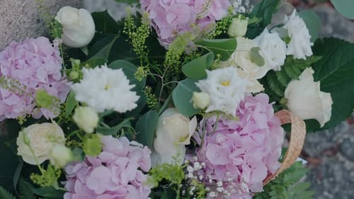 Close up of pastel wedding flower arrangement in basket
