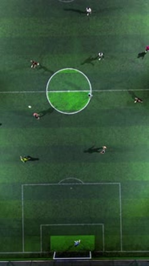 Vertical Drone Footage of mini football match, soccer. MiniFootball field and Footballers from drone