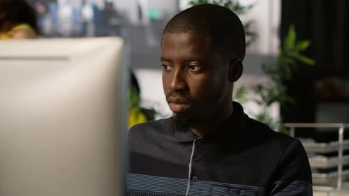 Young Professional Working at Computer in Office