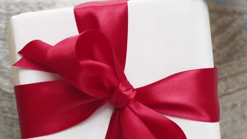 Gift Presented with Red Bow Celebration Close Up
