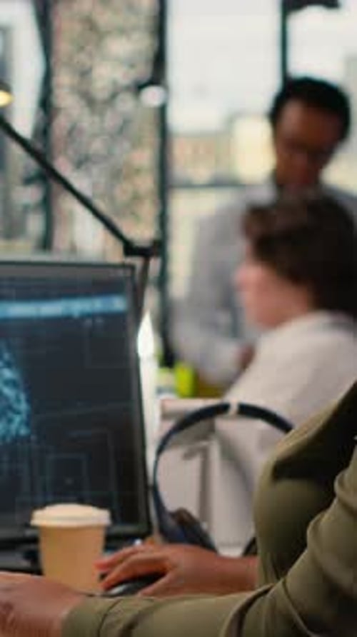 Vertical Video System Administrators Brainstorming in Office Using AI Specialized Hardware