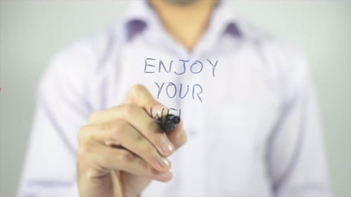 Man Writes Enjoy Your Week on Clear Surface