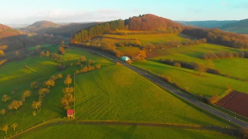 drone flight over open country road with some traffic