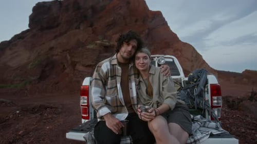 Portrait of Young Romantic Couple Enjoying Stopover in Desert during Road Trip