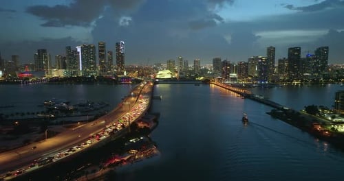 Traffic Congestion on American Freeway Bridge at Night with Slowly Driving Cars in Miami City