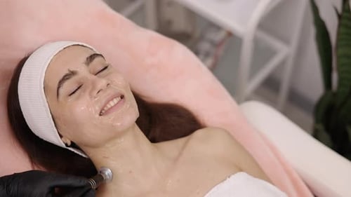 Woman Receiving Facial Treatment at Cosmetology Clinic