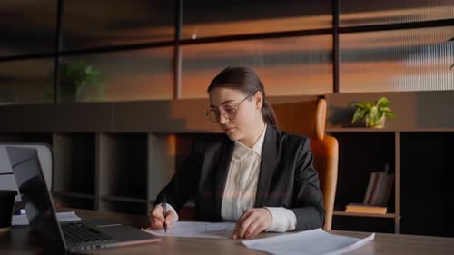 Young Professional Woman Working at Desk in Office