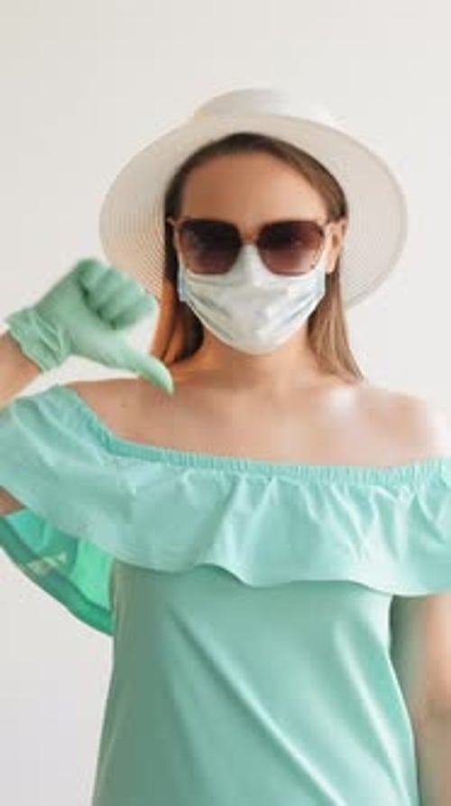 Woman Wearing Mask, Gloves Gives Thumbs Down