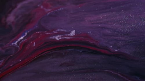 Abstract Mixing of Red and Purple Liquids with Glitter