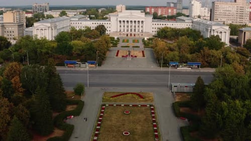 Bird's-eye view of the parks. Stock footage. Small white buildings around parks with green trees