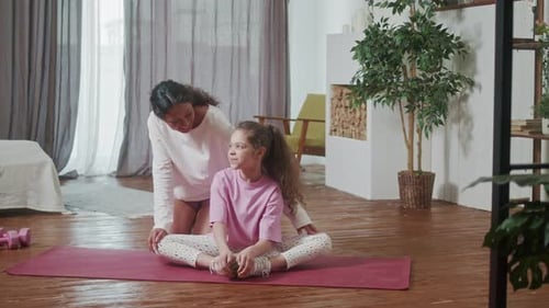 Mother and Little Cute Daughter Doing Stretching Exercises Training Together Cozy Home