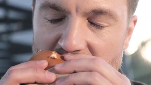Businessman Eats a Tasty Burger Fast Street Food