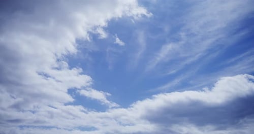 Clouds Drifting Slowly Across Blue Sky