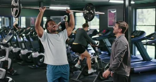 Barbell, personal trainer and weightlifting with man in gym for strong, fitness and muscle workout