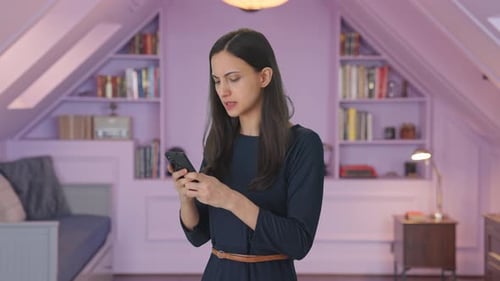 Woman Using Mobile Phone in Cozy Room