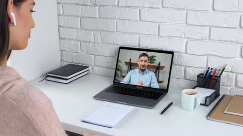 Woman On Video Call at Desk with Laptop