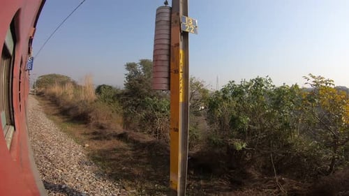 Train window leaning out point of view during long distance train ride travel, Indian Railways