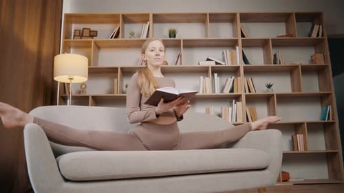 Flexible Young Woman Reading Book in Splits