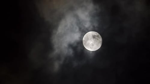 Dramatic Full Moon Through Clouds at Night