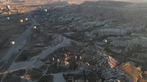 Aerial View of Fairytale Landscape of Cappadocia, Turkey With Hot Air Balloons Flying Above on Sunny