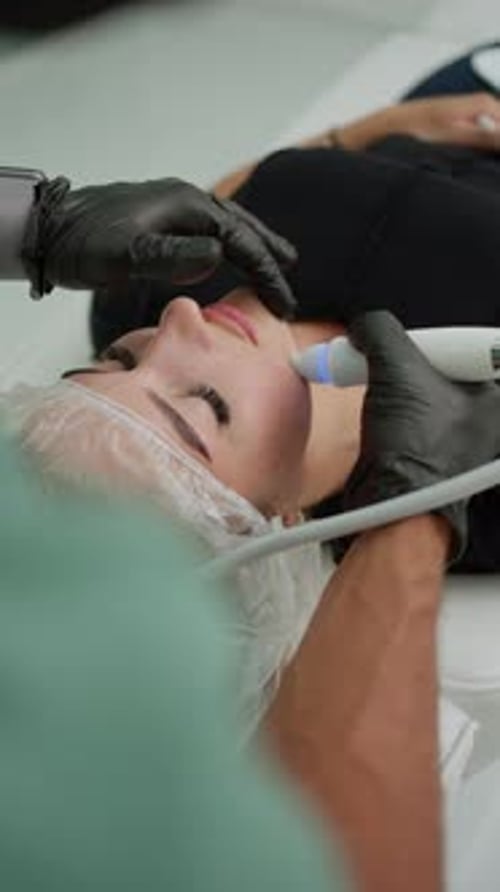Woman Receives Facial Treatment in Clinic