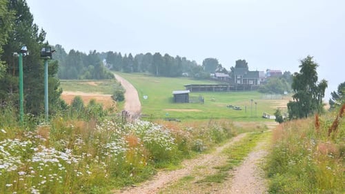 Rural Landscape with Dirt Road and Distant Village