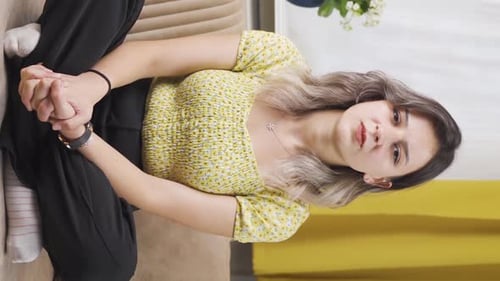 Woman Sitting Cross-Legged on Couch Indoors