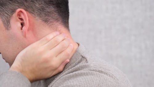 Man Massaging Neck for Pain Relief