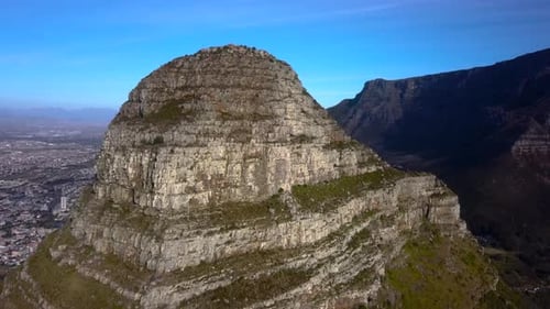 Lions Head Mountain Peak with Sea Point and Table Mountain in the background on a Clear Blue Sky Day