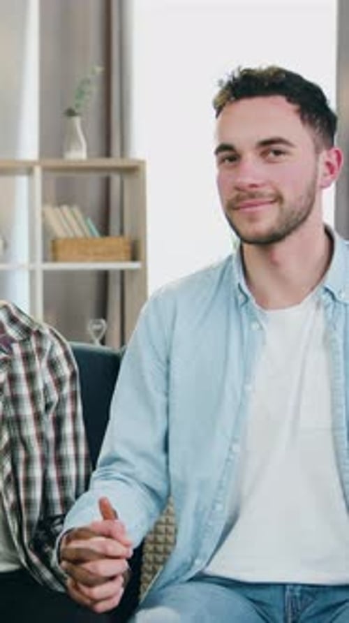 Affectionate Young Couple Holding Hands in Home