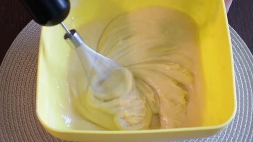 Batter Being Mixed in Yellow Bowl With Whisk