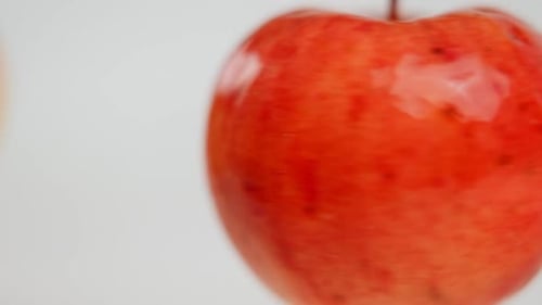 Closeup Tasty Apple Spinning Fast with Blurred Fruit Hanging at Background Closeup Delicious Ripe