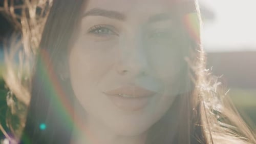 Close Up Face Young Attractive Woman at Sunset Smiling Look at Camera Windy Around Stand Outdoor