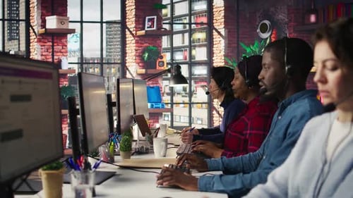 Call Center Employees Wearing Headset Assisting Customers in Office Close Up