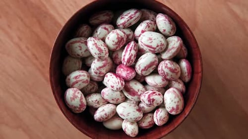 Cranberry Beans Spinning Borlotti Bean Pods in Wooden Bowl Top View Stylish Modern Food Background