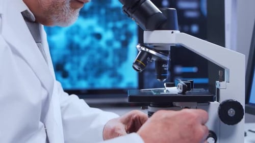Senior Scientist Using Microscope in Laboratory