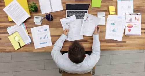 Hr Manager Studies Vacancy Candidates Resumes At Workplace. Businessman Chooses Talents.