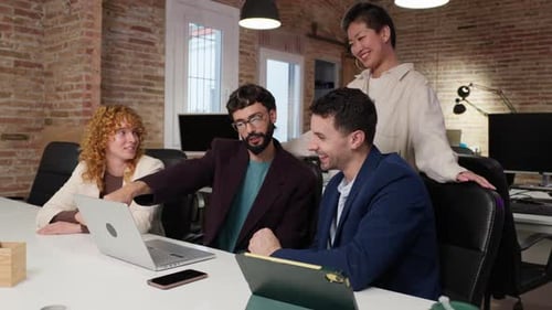 Office Team Discussing Work at Table