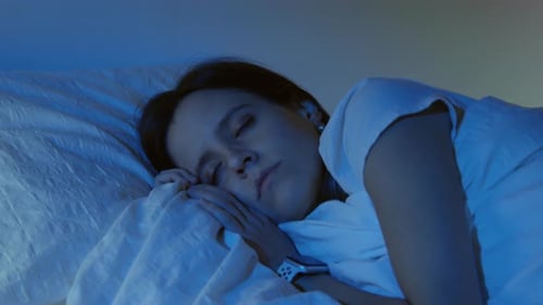 Woman Sleeps Peacefully in Bed at Night