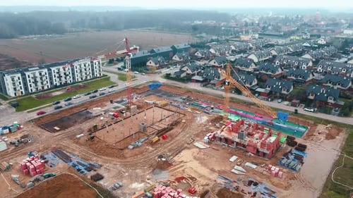 Construction Site with Cranes Building New Houses