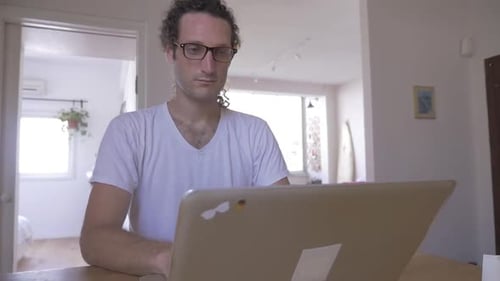 Young Adult Working on Laptop at Home