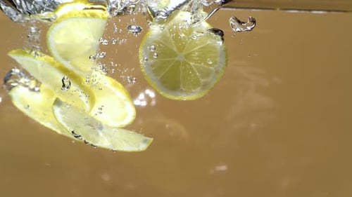 Lemon Slices Falling into Water