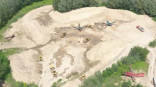 Industrial equipment at mining area. Sky view of mining equipment at sand mine. Mining conveyor work